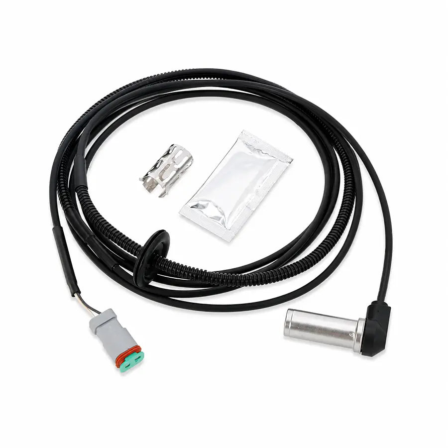A black coiled cable assembly with a gray and green connector on one end and a silver metal cylindrical component on the other, shown with a small silver clip and a sealed plastic packet on a white background.