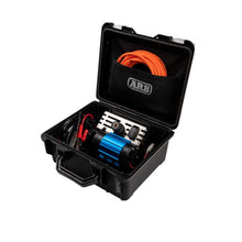 Black toolbox with automotive parts including a blue pump and orange cable, on a white background.
