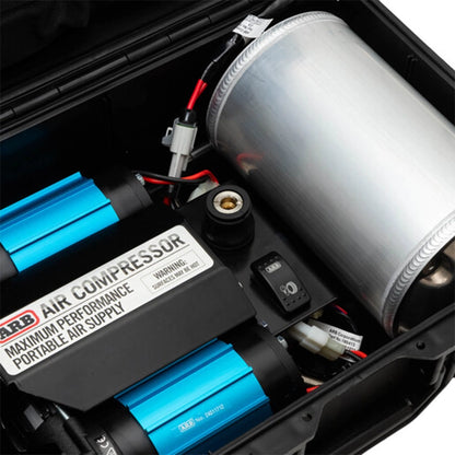 Close-up of a portable air compressor with visible branding and components.