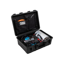 Black toolbox with tools and equipment on a white background