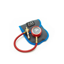 Air pressure gauge with red hose on a white background