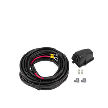 Coiled black cable with connectors on a white background