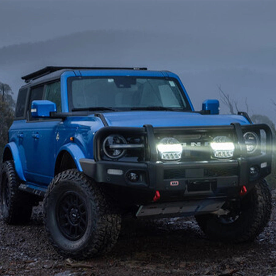 Blue off-road vehicle on a mountainous road