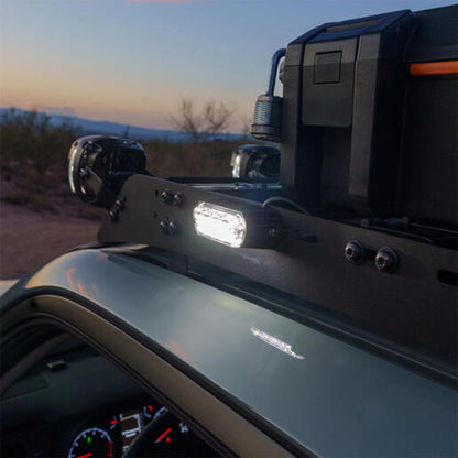 Close-up of a vehicle's dashboard with a mounted light at sunset.