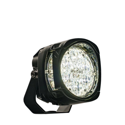 Black off-road light with clear lens on a white background