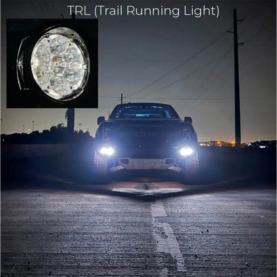 Truck on a road at night with a close-up of a trail running light labeled 'TRL'.