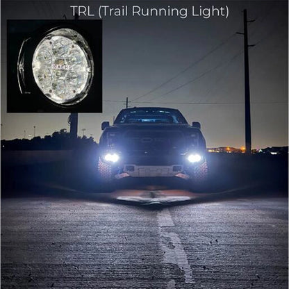 Truck on a road at night with a close-up of a trail running light labeled 'TRL'.