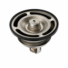 A metal automotive thermostat with a black rubber gasket and a small green center pin, shown on a plain white background.